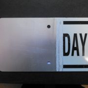 Partially Hydrostripped Aluminum Sign Aluminum traffic sign partially stripped of reflective sheeting to demonstrate the hydrostripping process and exposed bare metal surface.